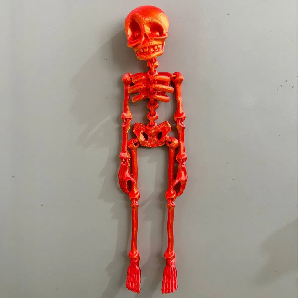 3D printed white skull Halloween fridge magnet, 18cm high, on a refrigerator door.