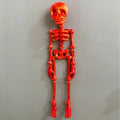 3D printed white skull Halloween fridge magnet, 18cm high, on a refrigerator door.