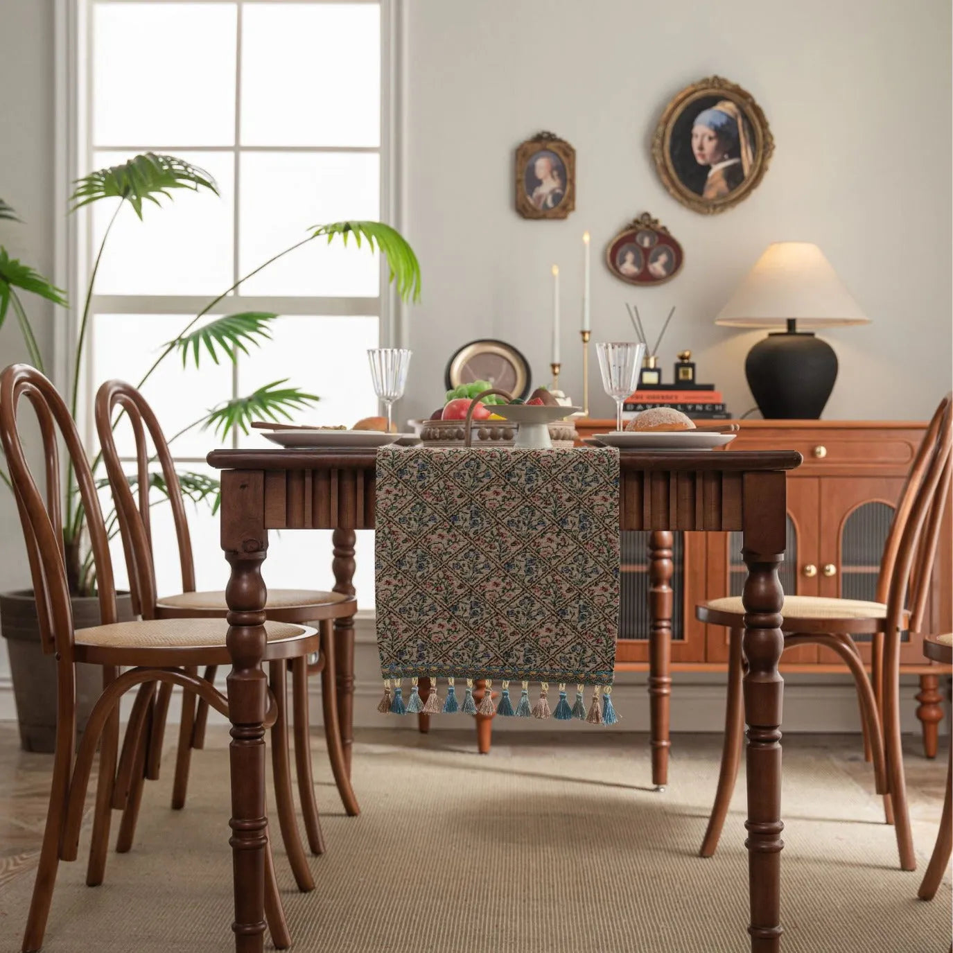 Nordic striped jacquard table runner with tassel on a dark wooden dining table.