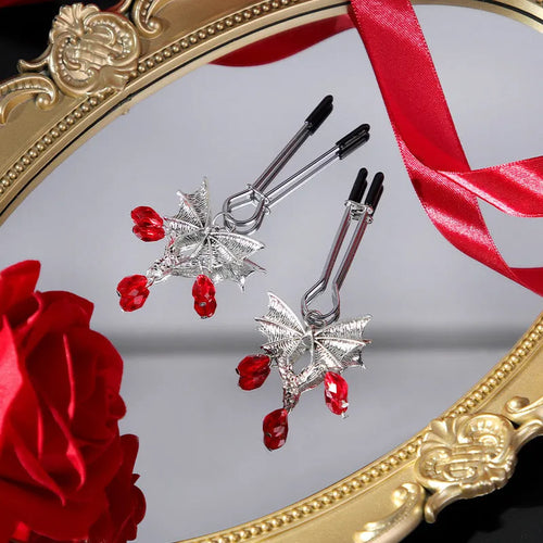 Silver bat nipple clamp with ruby design and adjustable pressure mechanism