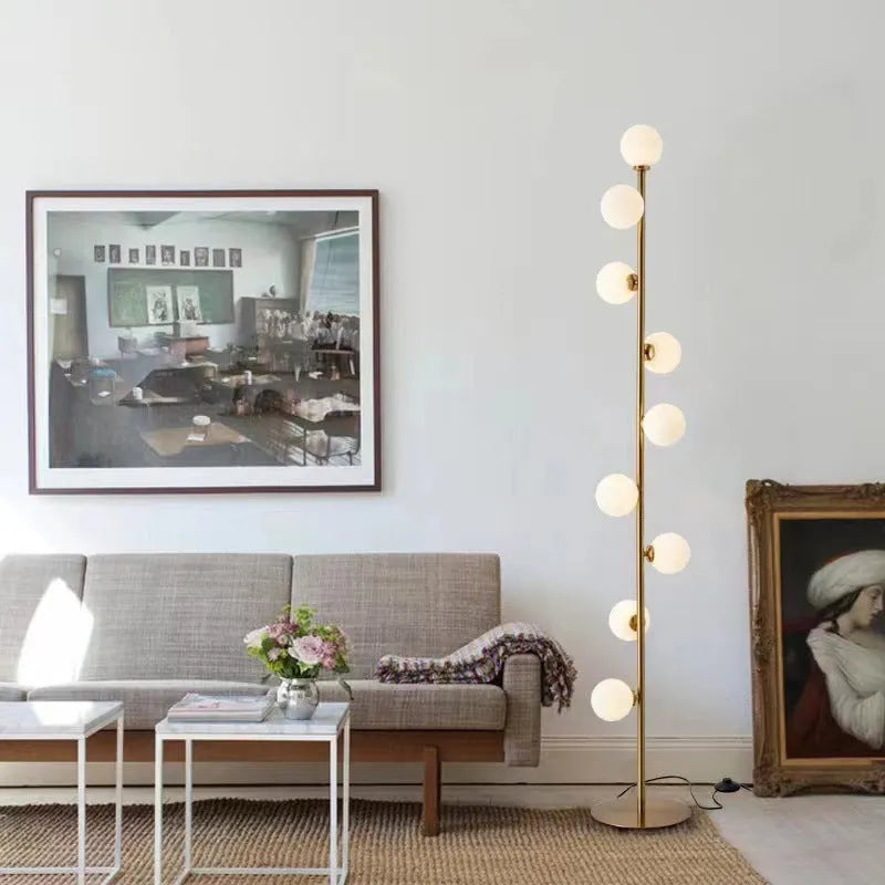 Modern minimalist floor lamp with wrought iron frame and round marble base, showing four light colour options.