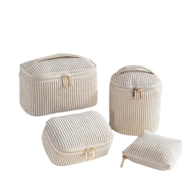 Set of four cube-shaped pink flannelette makeup bags with zips, one showing a removable interior divider and a metal hook.