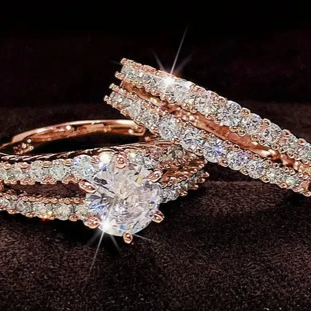 2 in 1 fully jewelled female fashion ring set in silver, gold, and rose gold on a geometric background.