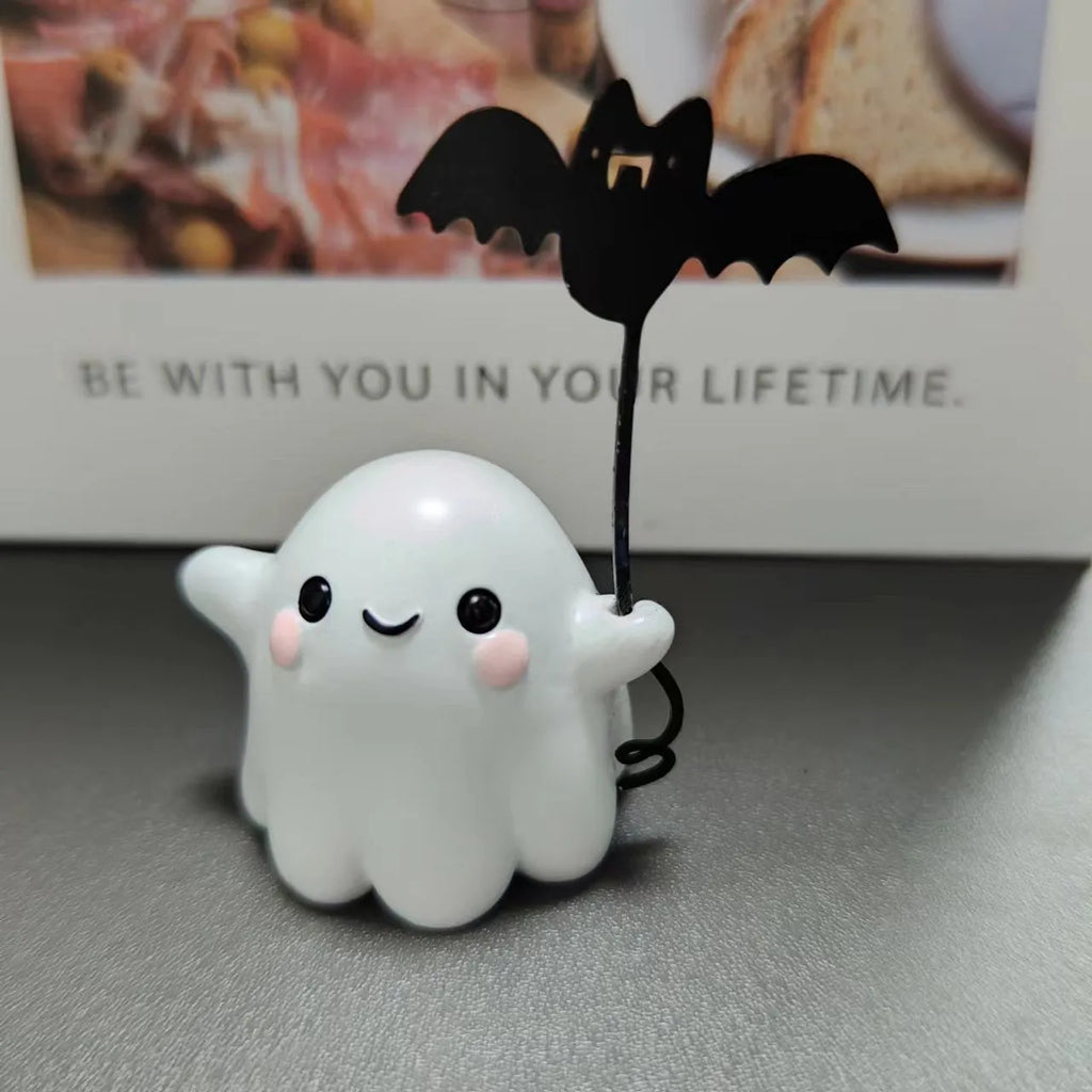 Miniature white ghost dog walking statue holding a small black bat, resin Halloween ornament