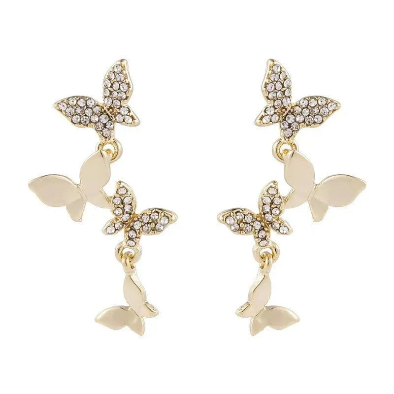Gold-colour women's drop earrings with four butterfly charms made from copper