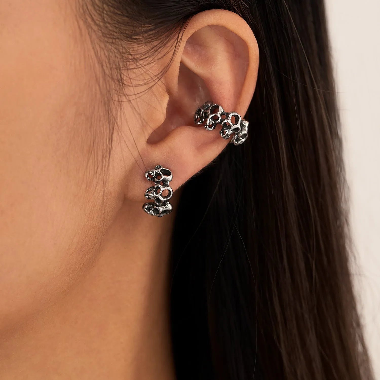 Stainless steel skull ear clips with hollow geometric design and clip-on backing