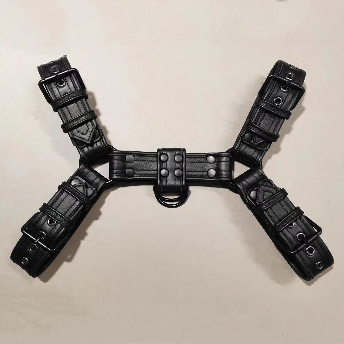 Black leather adjustable chest harness strap with metal buckle for men's costume and performance use