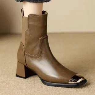 Brown women's high-heel Martin boots made of cowhide leather with a side zipper and decorative rivets.