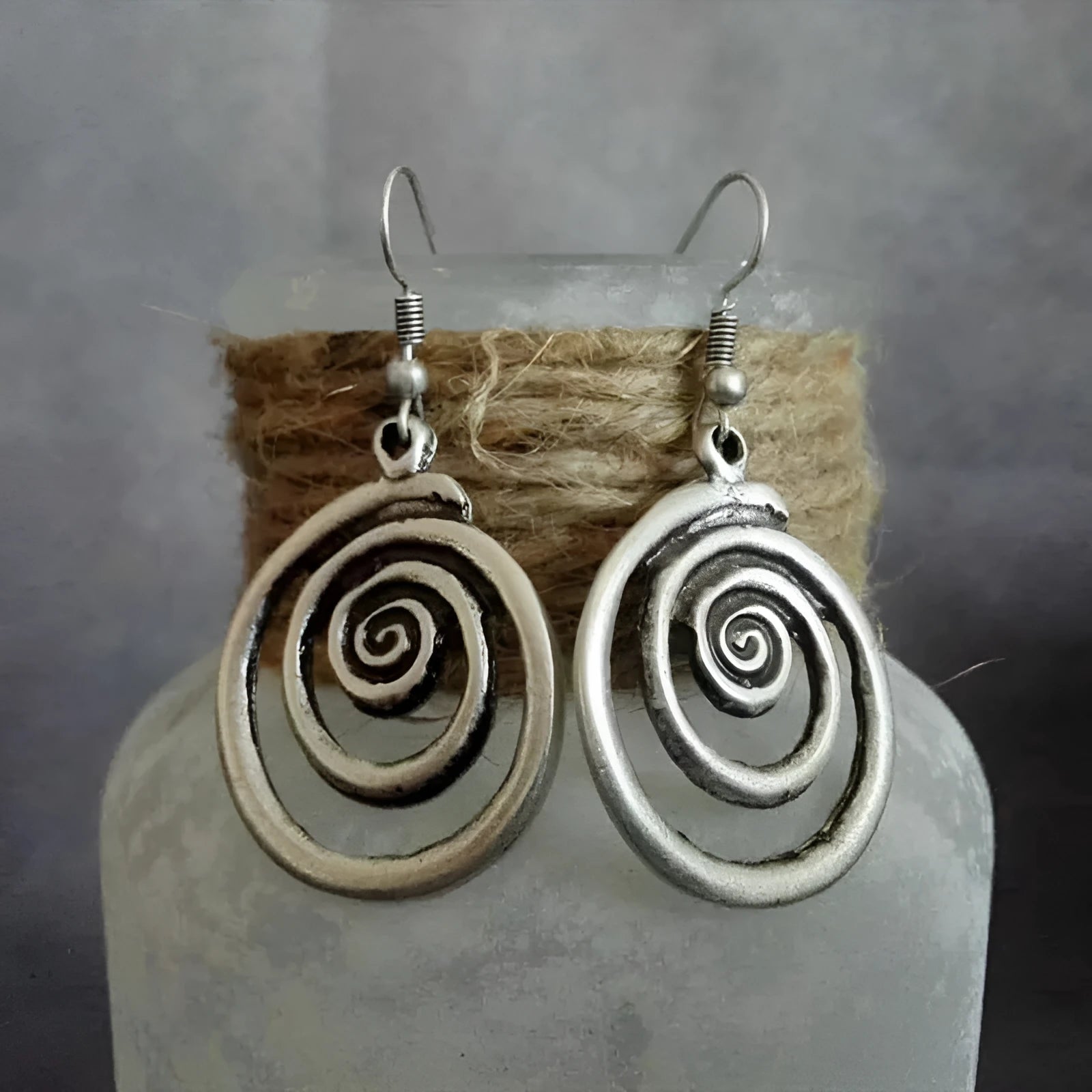 Silver geometric spiral distressed earrings with a retro national style design.