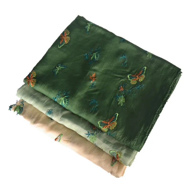 A piece of pure ramie fabric in beige, dark green and grass green, showing its texture and 140cm width.