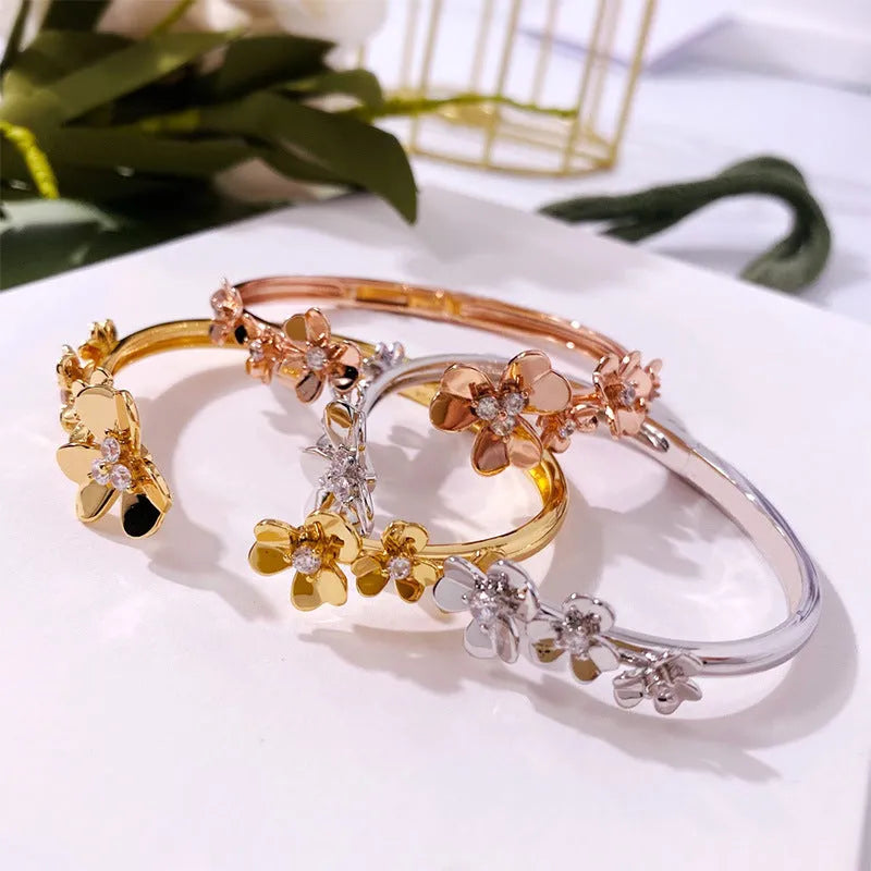 Three-leaf flower bracelet with micro inlaid zircon stones, copper base, electroplated in gold, silver, or rose gold