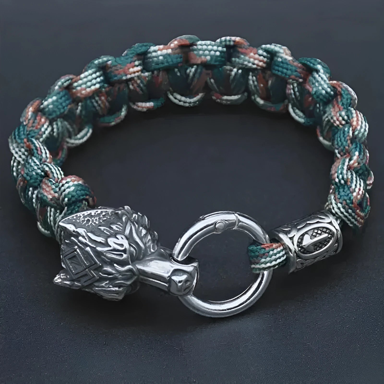 Handmade titanium steel wolf head bracelet with Luen character, polished finish, camouflage colour on white background