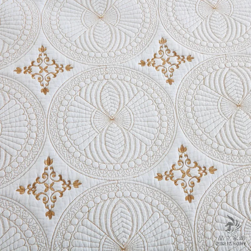 European-style embroidered pure cotton bed cover set with two pillowcases on a bed.
