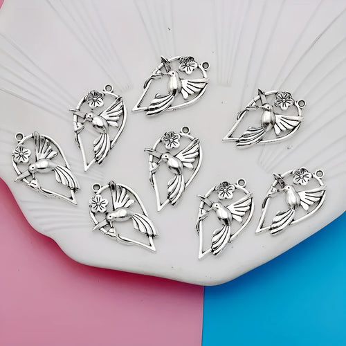 Gold tone alloy pendant with a detailed cast magpie design, shown from the front and back.