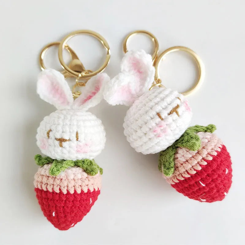 Hand-woven white doll wire pendant with a rabbit strawberry charm and an attached key
