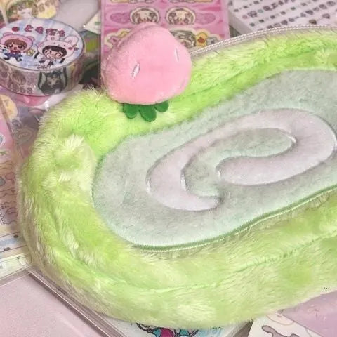 Honeydew green velvet pencil case with Swiss roll cake design, shown rolled up.