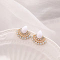 A pair of women's silver retro fan-shaped earrings with rhinestone and opal-like geometric details.