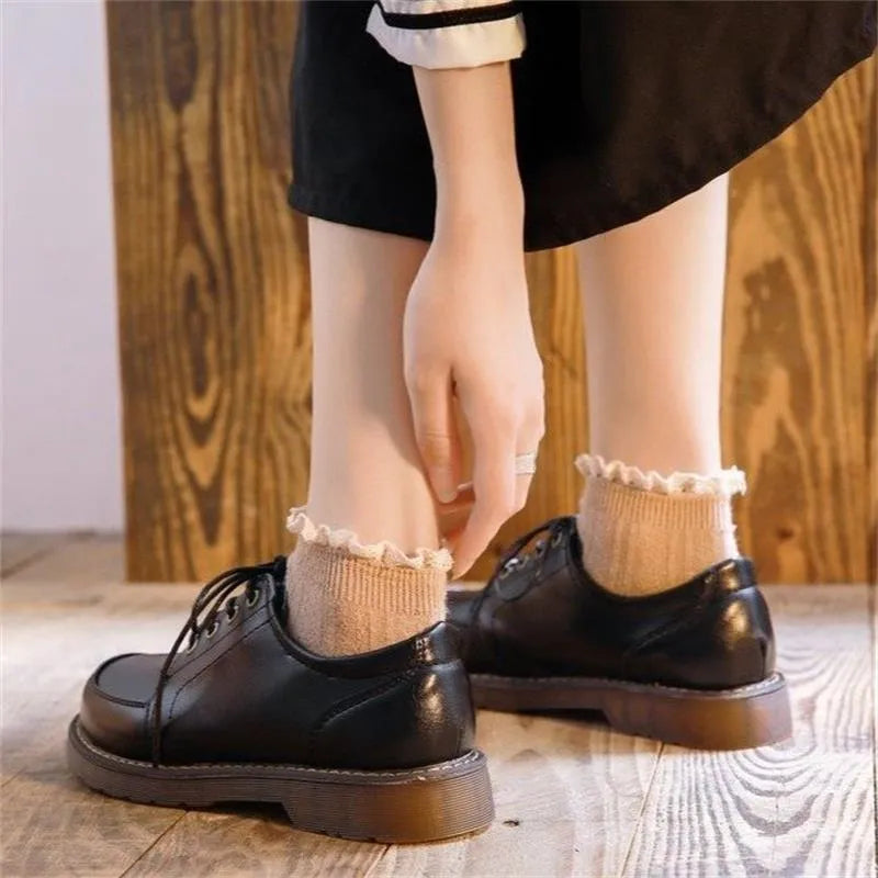 Women's preppy style black and brown retro Mary Jane lace-up pumps with low square heel.