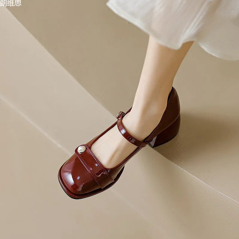 Women's apricot patent leather ankle boots with a chunky heel and ankle buckle.