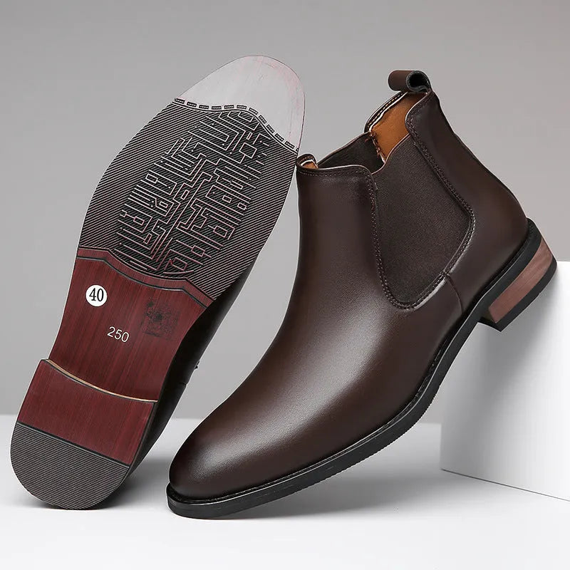 Men's black pointed-toe Chelsea boots with a low heel and rubber sole on a white background.