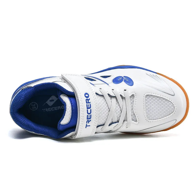White and blue low-top badminton shoes with a ribbed sole and wedge heel.