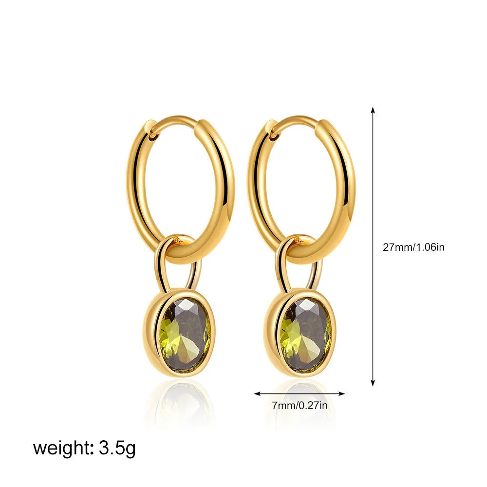 Close-up of women's retro-style copper earrings featuring a single oval-cut zircon stone in an emerald green colour.
