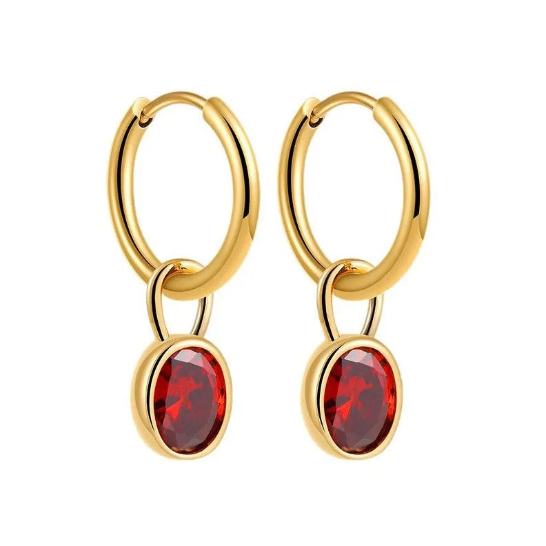 Close-up of women's retro-style copper earrings featuring a single oval-cut zircon stone in an emerald green colour.