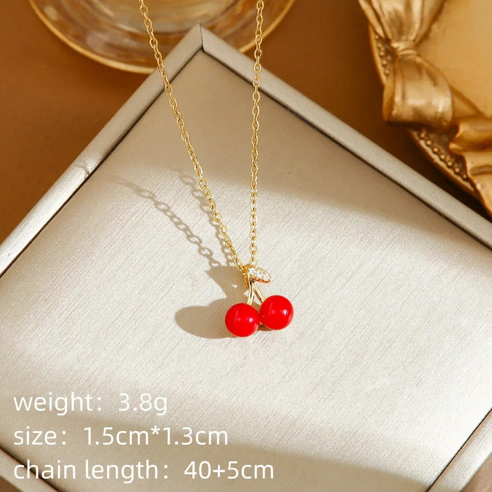 Red delicate indie necklace with cherry charm on a 50cm adjustable titanium steel O-ring chain.