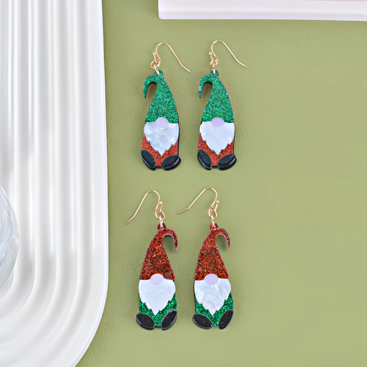 Acrylic cartoon Santa Claus earrings showing red, green, and red/green hat style options.