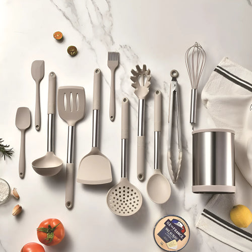 Black silicone kitchen utensil set with 12 tools stored in a rotating plastic storage bucket on a worktop.