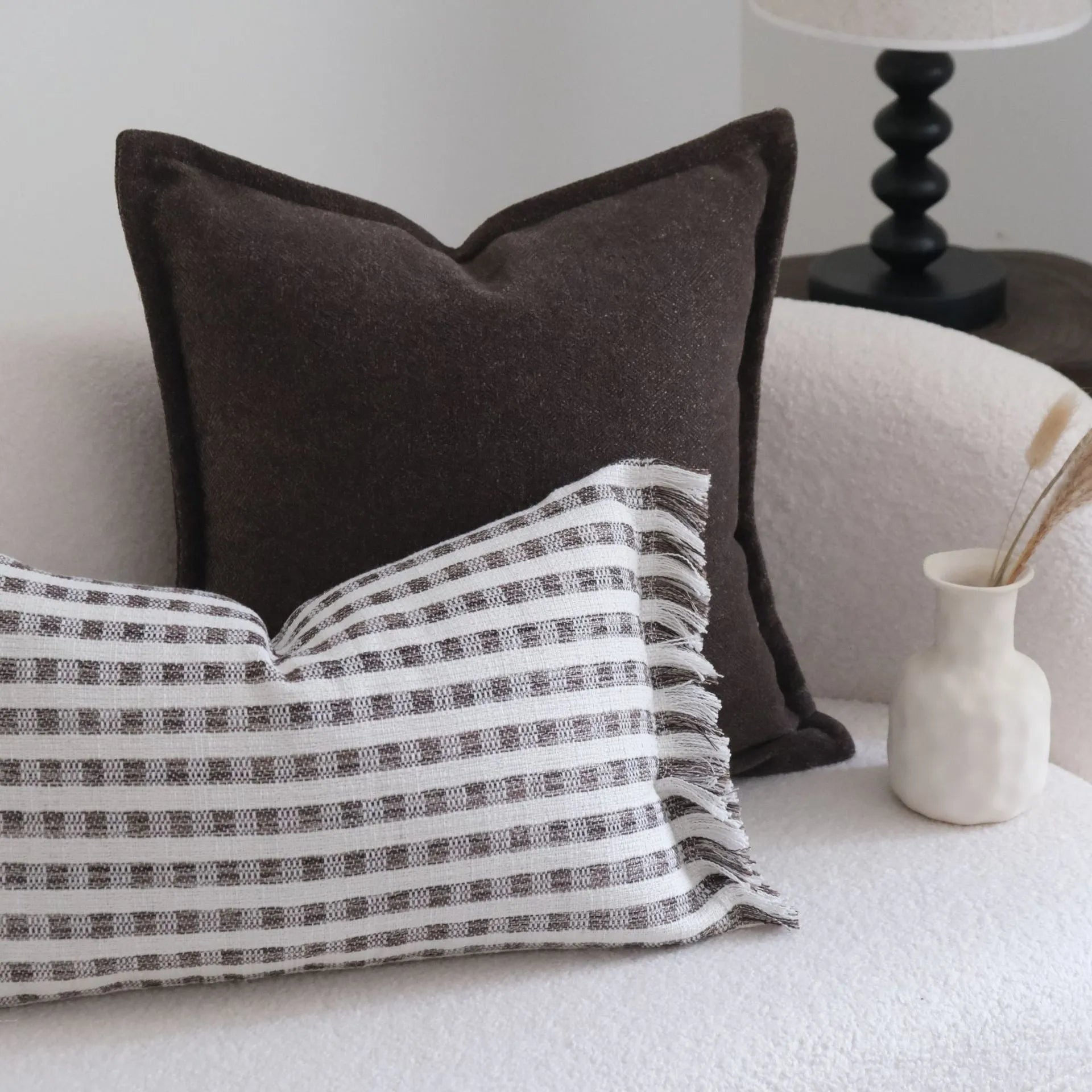 Coffee brown striped Chinese classical style decorative cushion on a sofa.