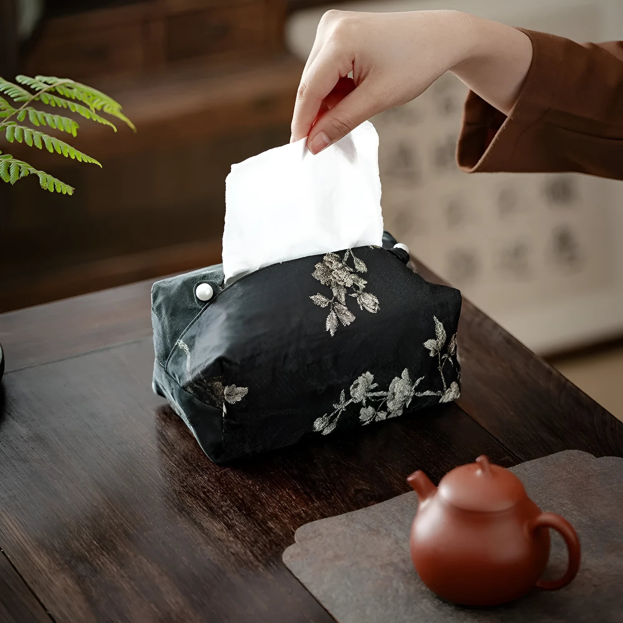 White embroidered plum blossom brocade tissue box cover with pearl buckle on table