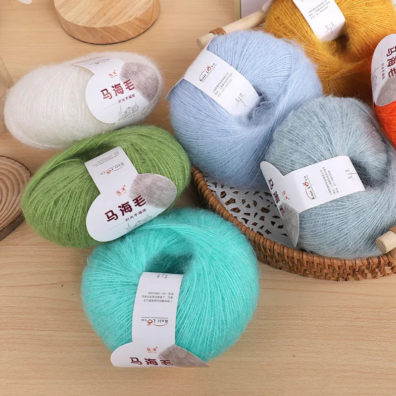DIY mohair scarf kit showing a ball of mohair thread in a chosen colour next to an example of a hand-woven scarf