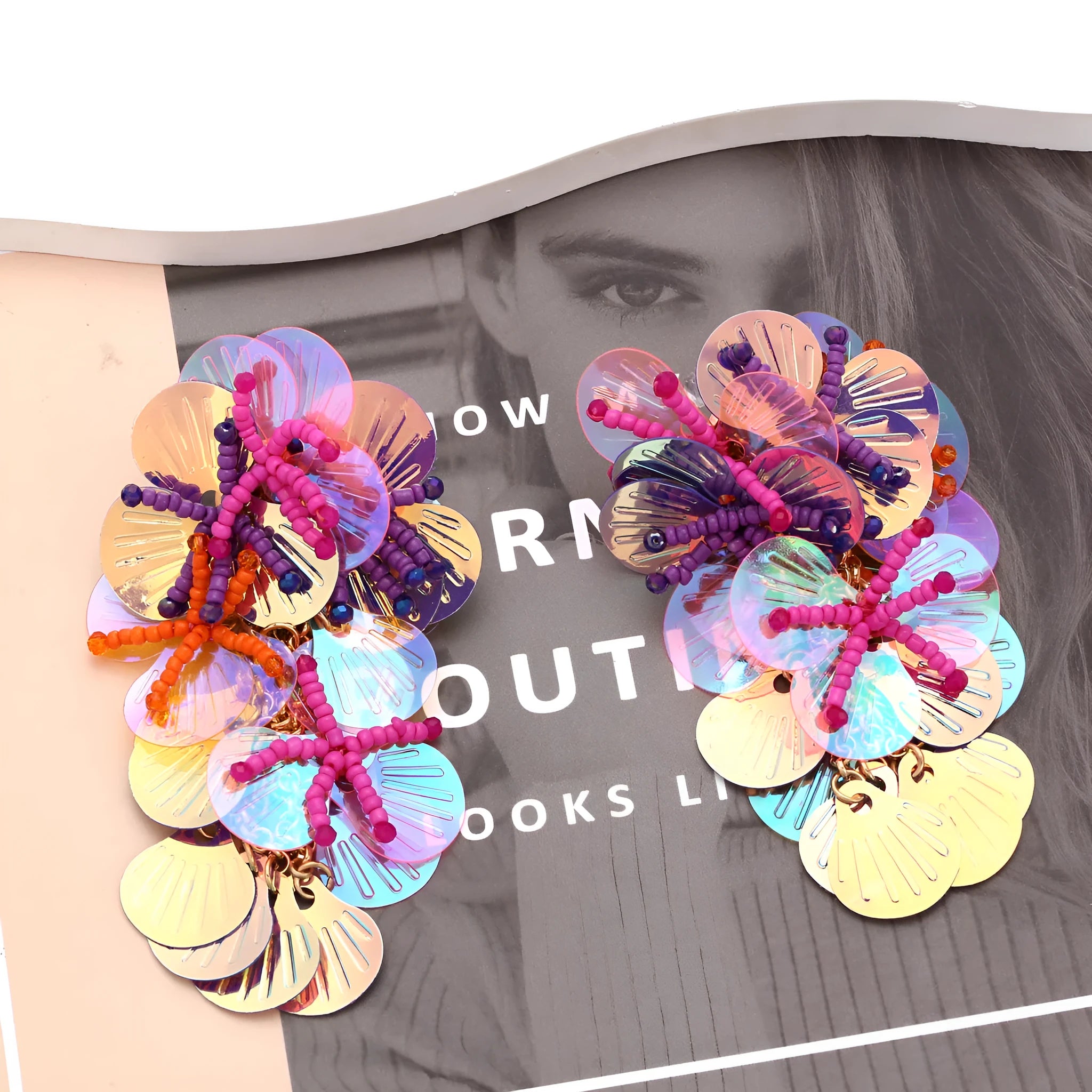 Handmade exaggerated string bead flower earrings in colourful, rose, or purple on a white background.