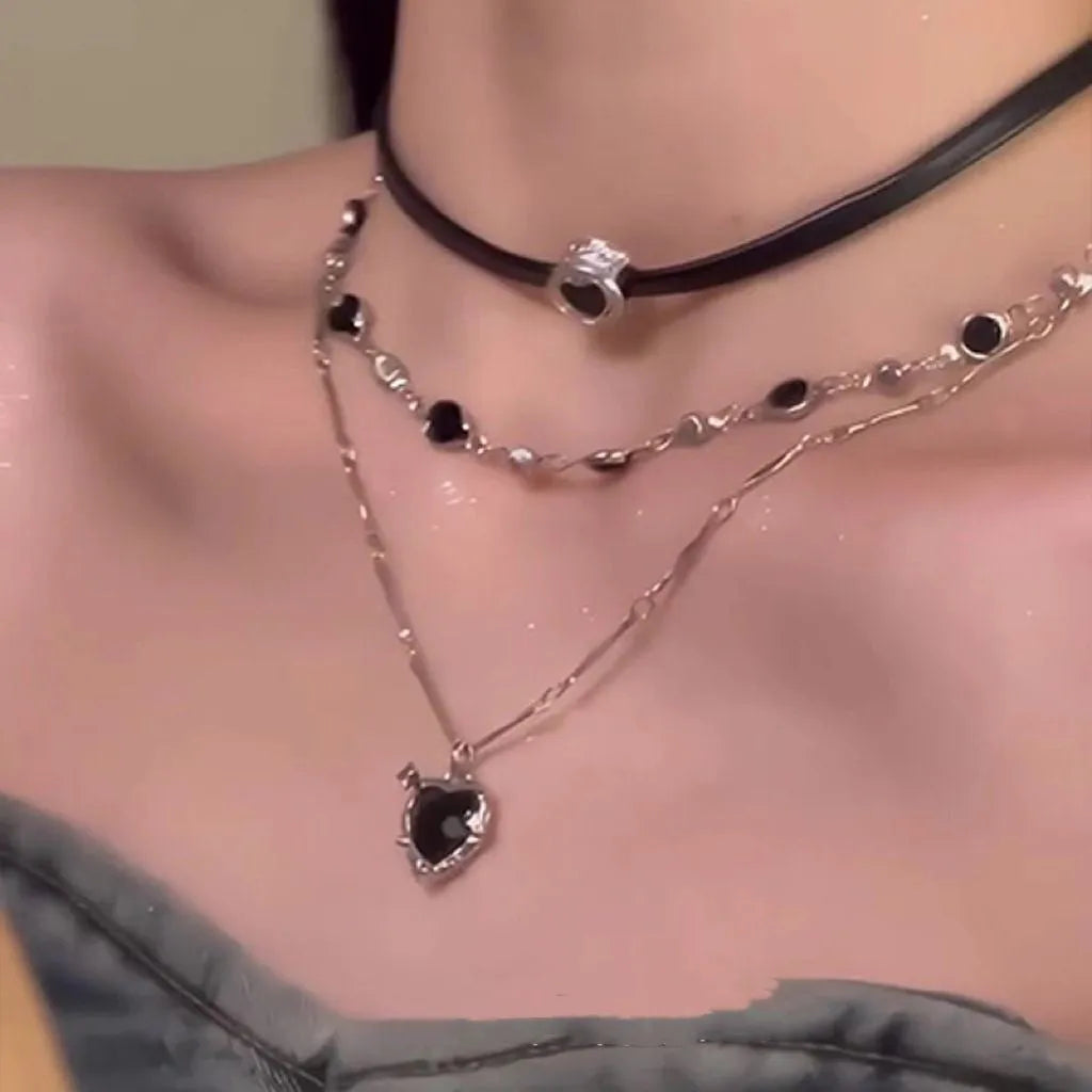 Women's adjustable multi-layer heart necklace set with alloy pendants and artificial crystal on a clavicle chain.