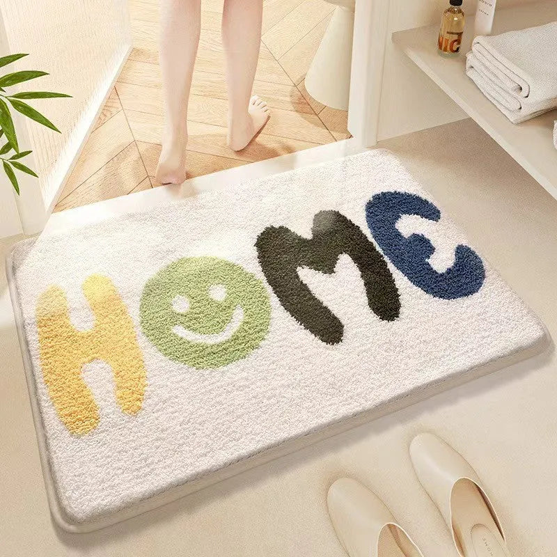 Square rainbow pattern floor mat in sky blue and white colours with a flat weave and plastic backing.