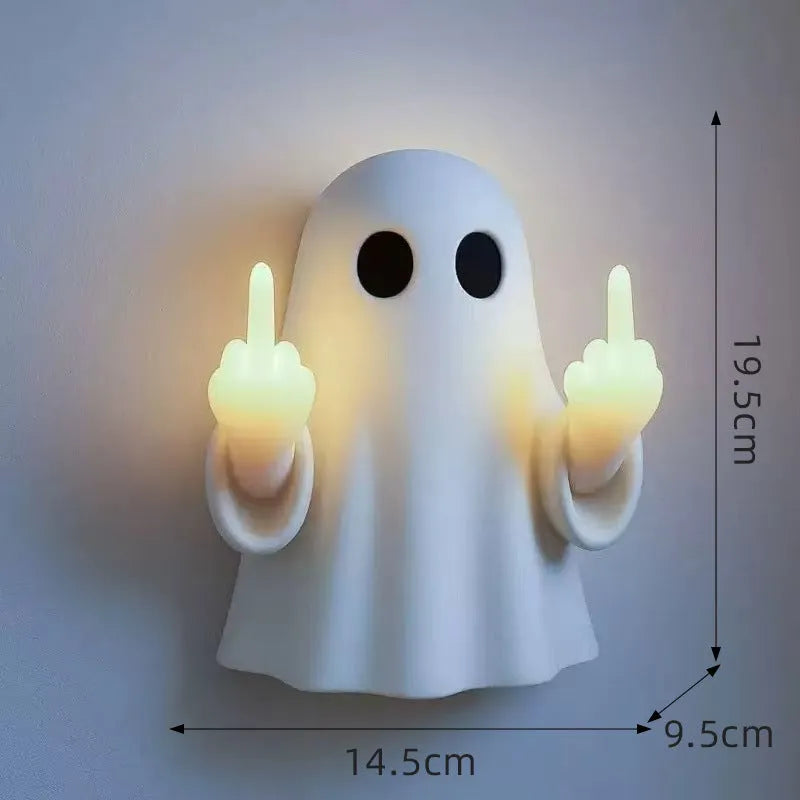 White cute ghost statue plastic night lamp for Halloween decoration on a dark surface.