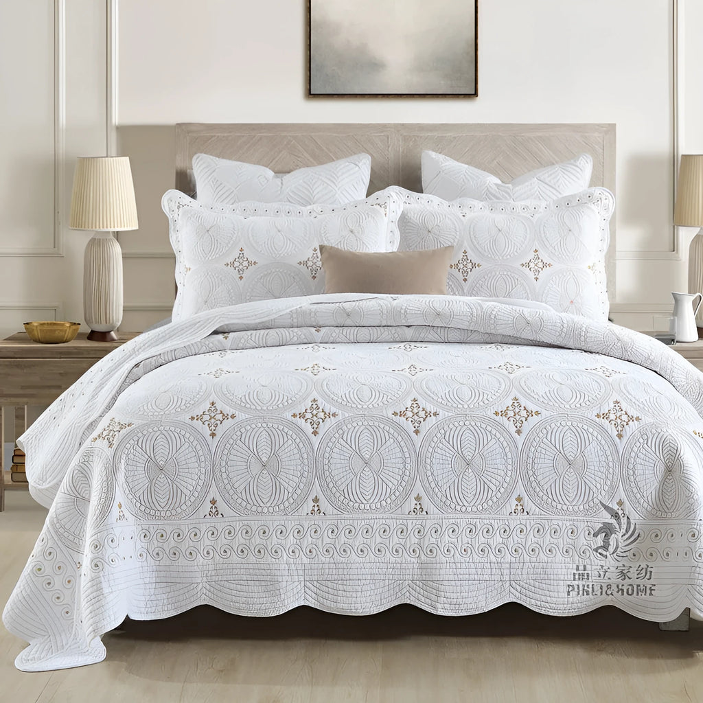 European-style embroidered pure cotton bed cover set with two pillowcases on a bed.