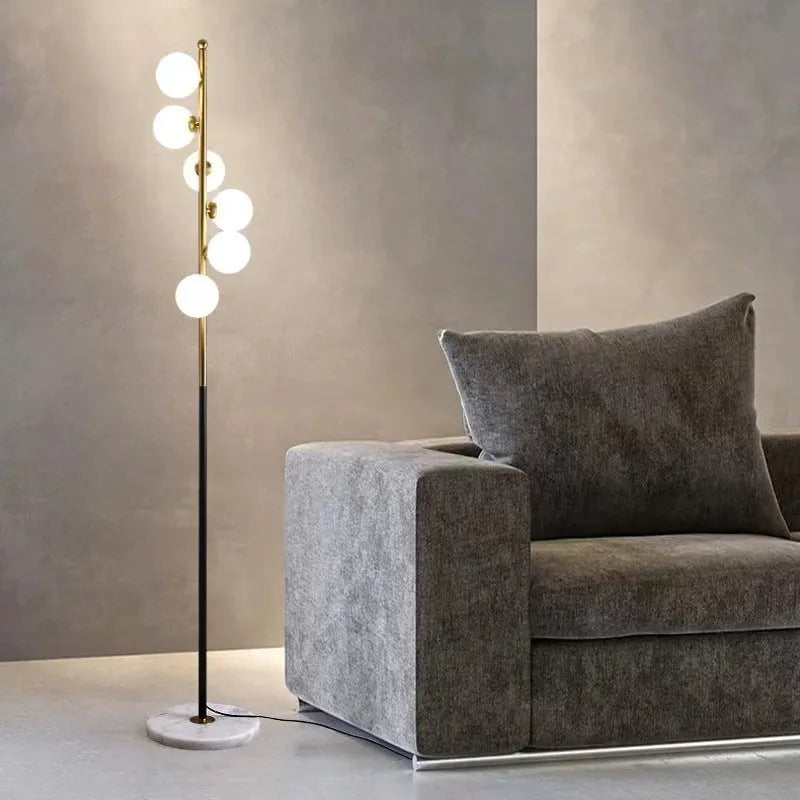 Modern minimalist floor lamp with wrought iron frame and round marble base, showing four light colour options.