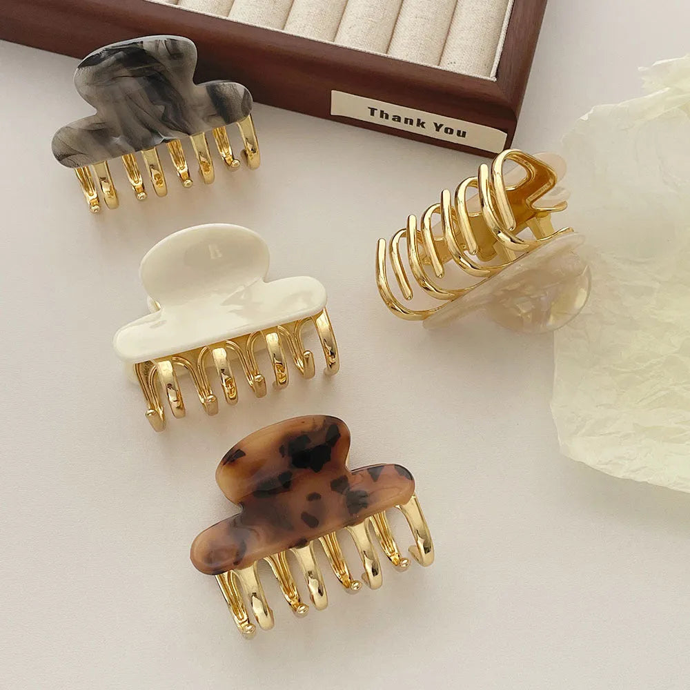 A medium-sized retro acetate hair barrette with a metal grip in a choice of four colours.
