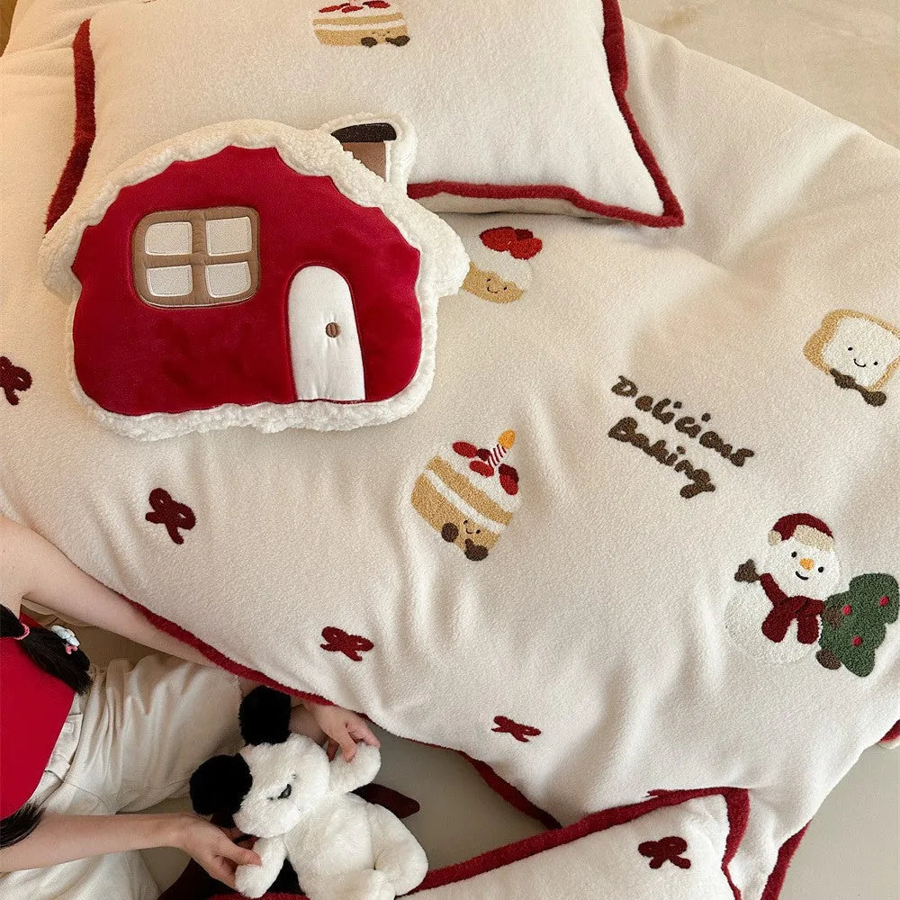 Cartoon pattern winter bedding four-piece set including bed sheet, duvet cover, and pillowcases on a bed.