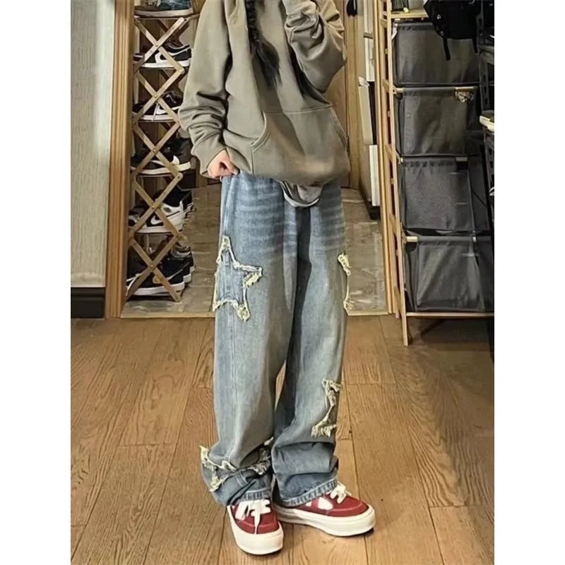 Women's blue high-waisted straight-leg jeans laid flat on a surface.