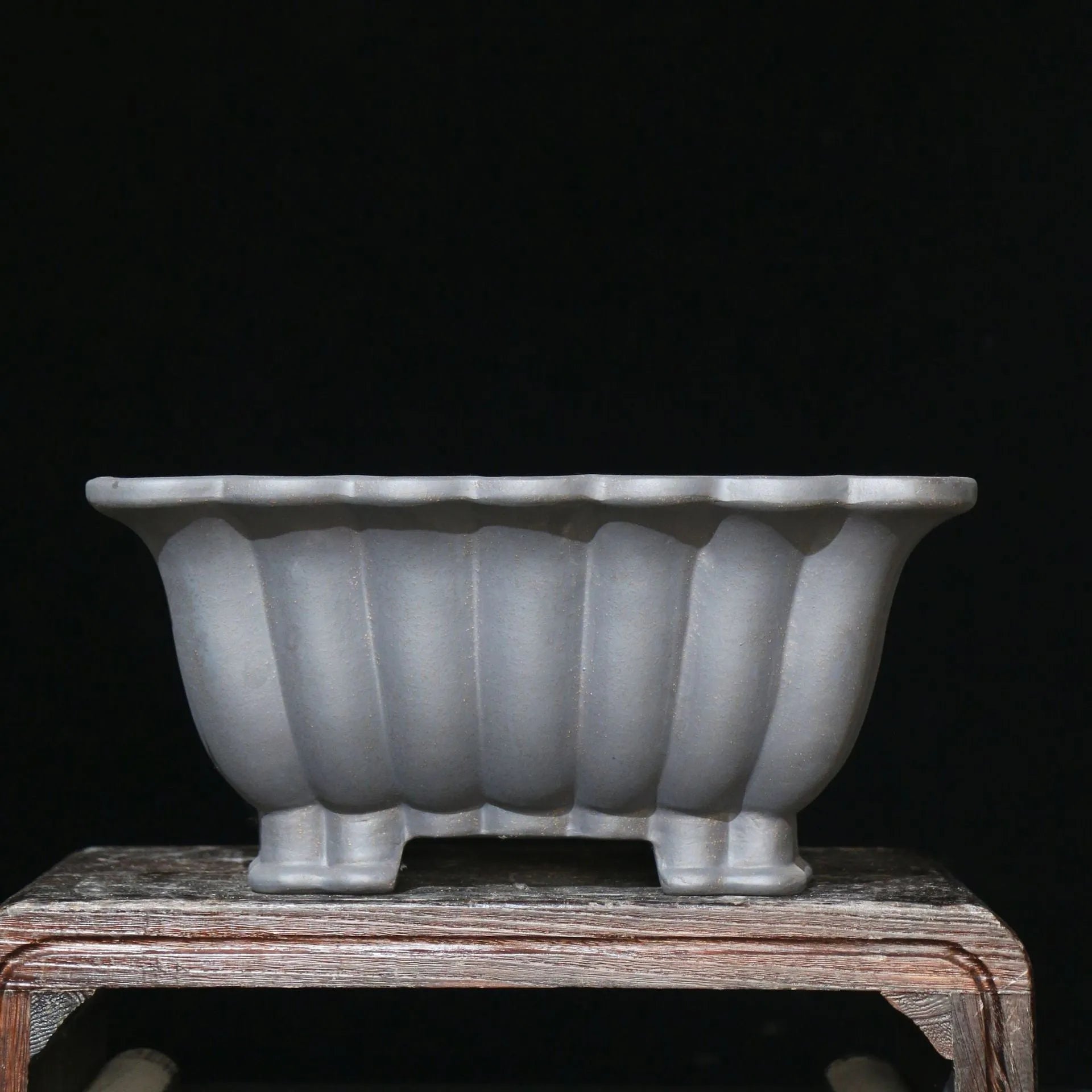 Square purple sand ceramic bonsai pot with du xiliang glaze on a desktop.