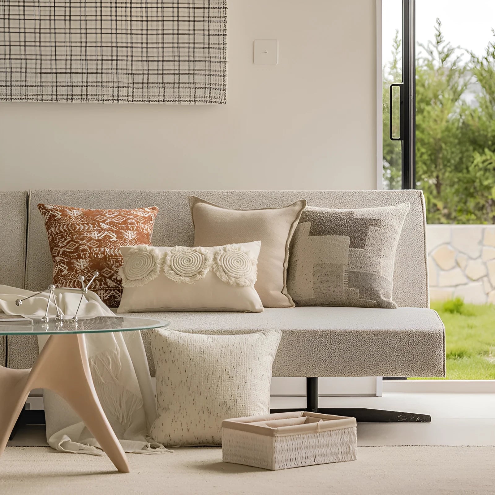 A square solid-colour cushion pillow on a sofa, showing its plain edge detail.