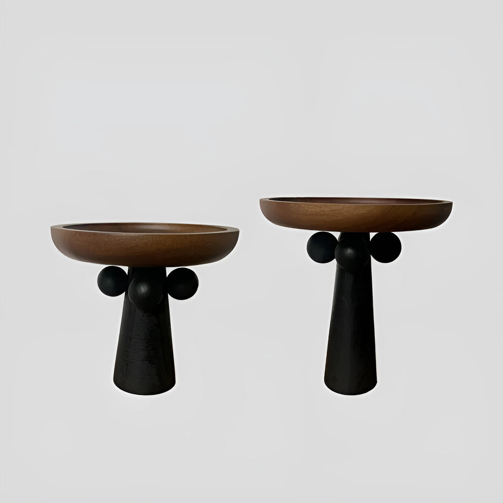 Nordic style round wooden tray with high legs for displaying candles and aromatherapy items.
