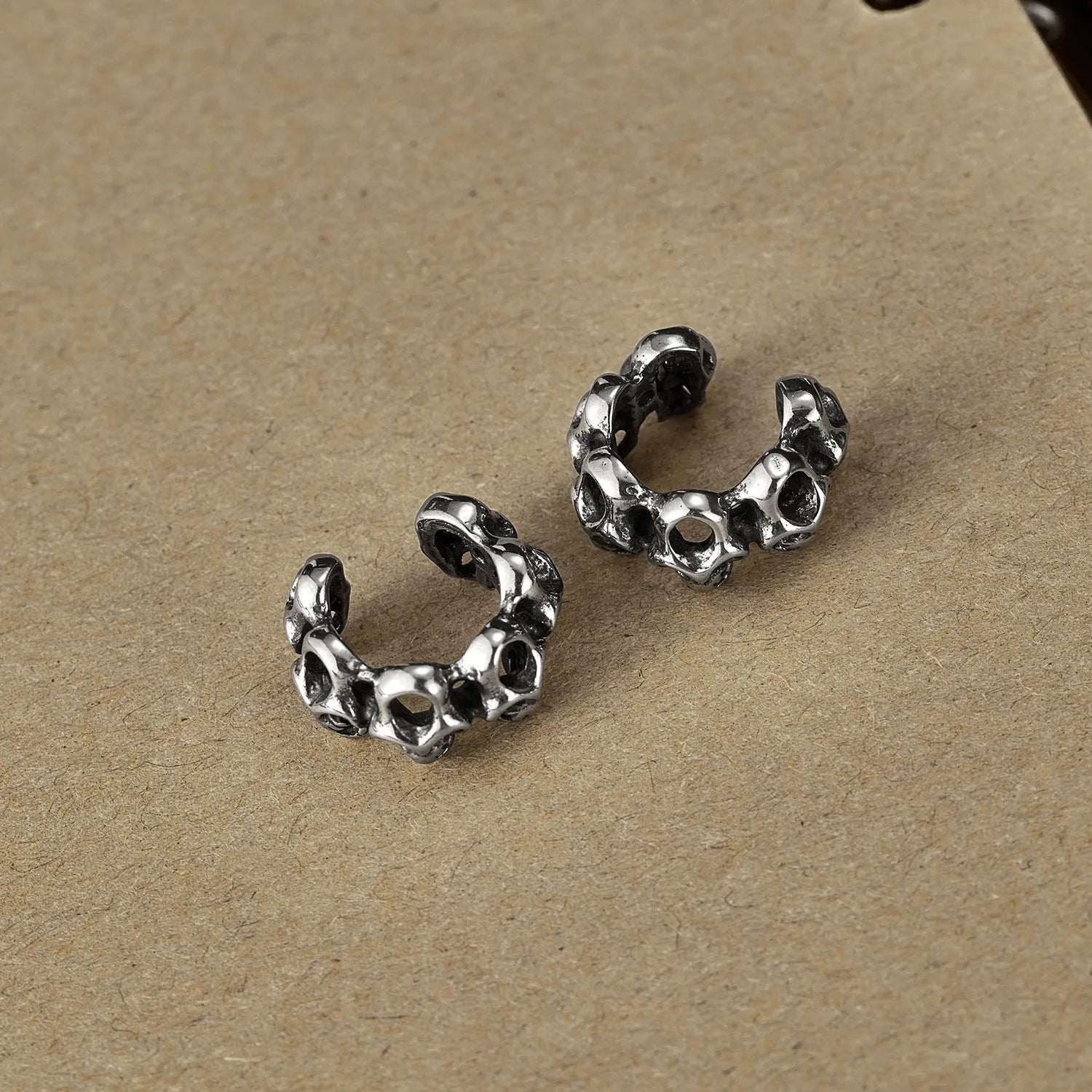 Stainless steel skull ear clips with hollow geometric design and clip-on backing