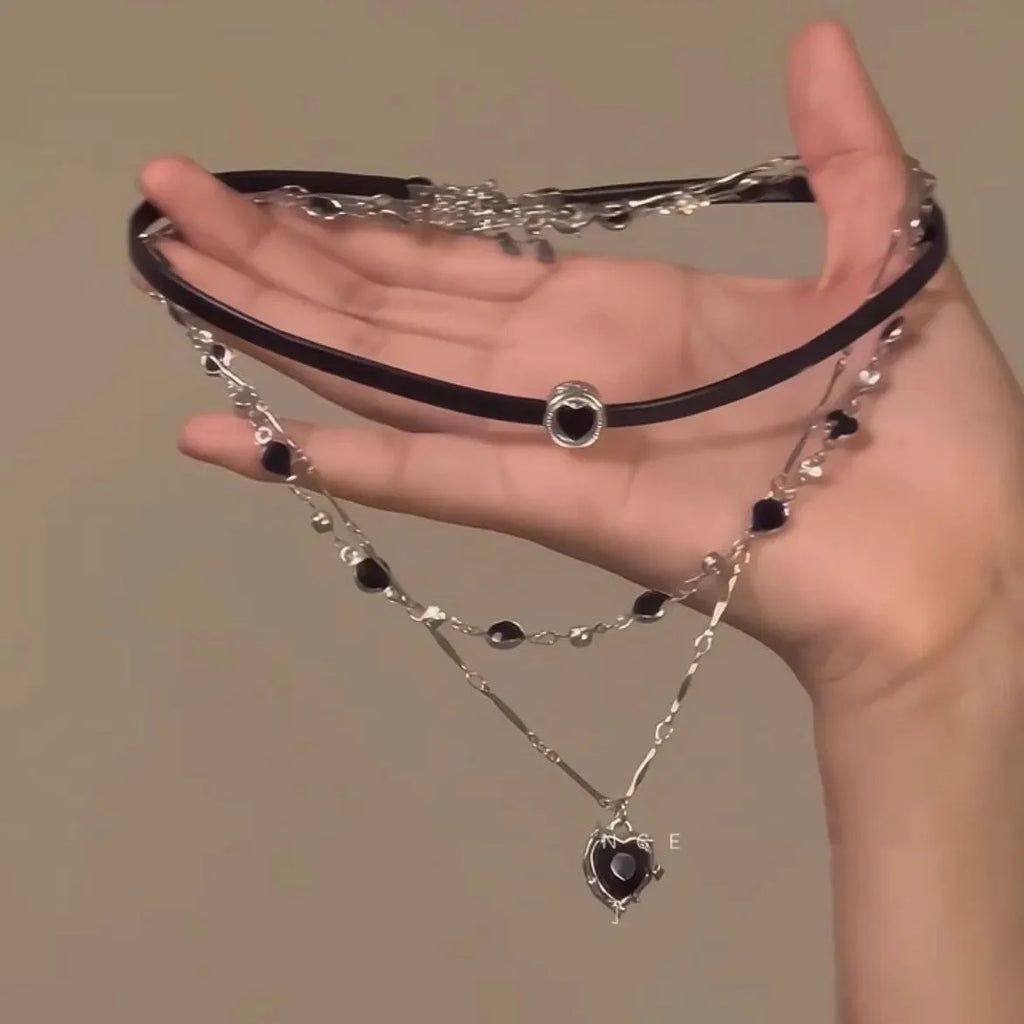 Women's adjustable leather heart pendant necklace with alloy chain and artificial crystal details on a model.