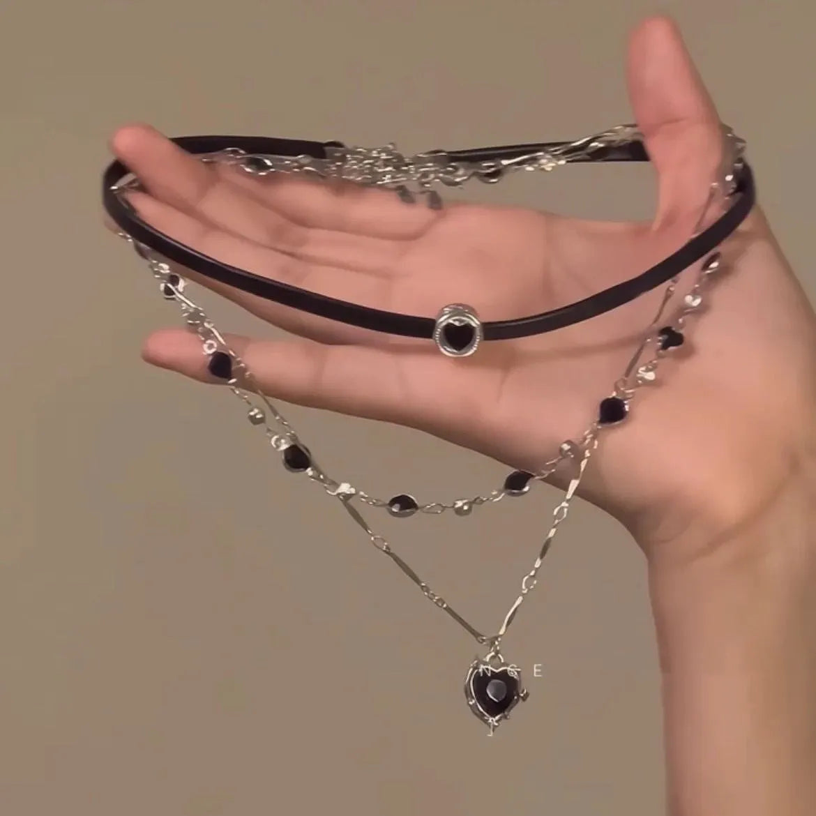 Women's adjustable multi-layer heart necklace set with alloy pendants and artificial crystal on a clavicle chain.