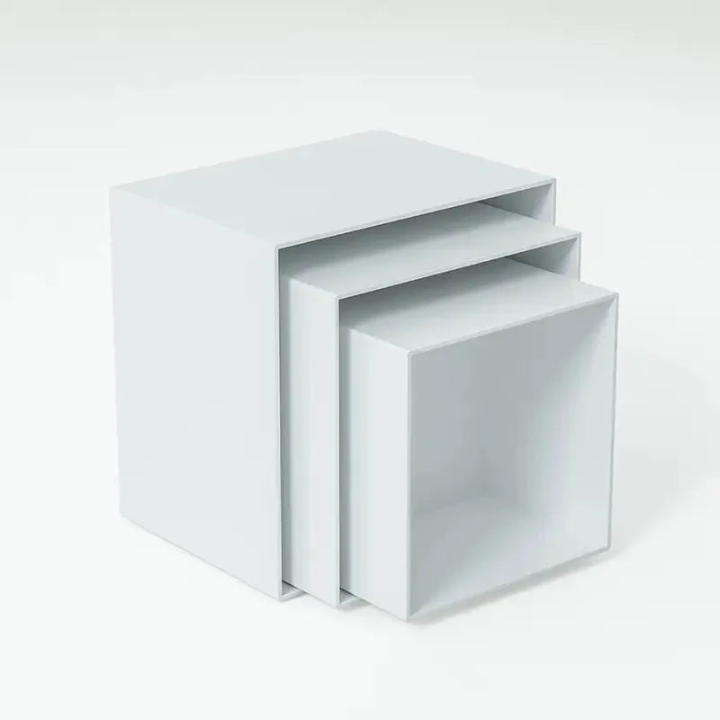 White plastic cube-shaped dessert display stand with multiple tiers for cupcakes and pastries.
