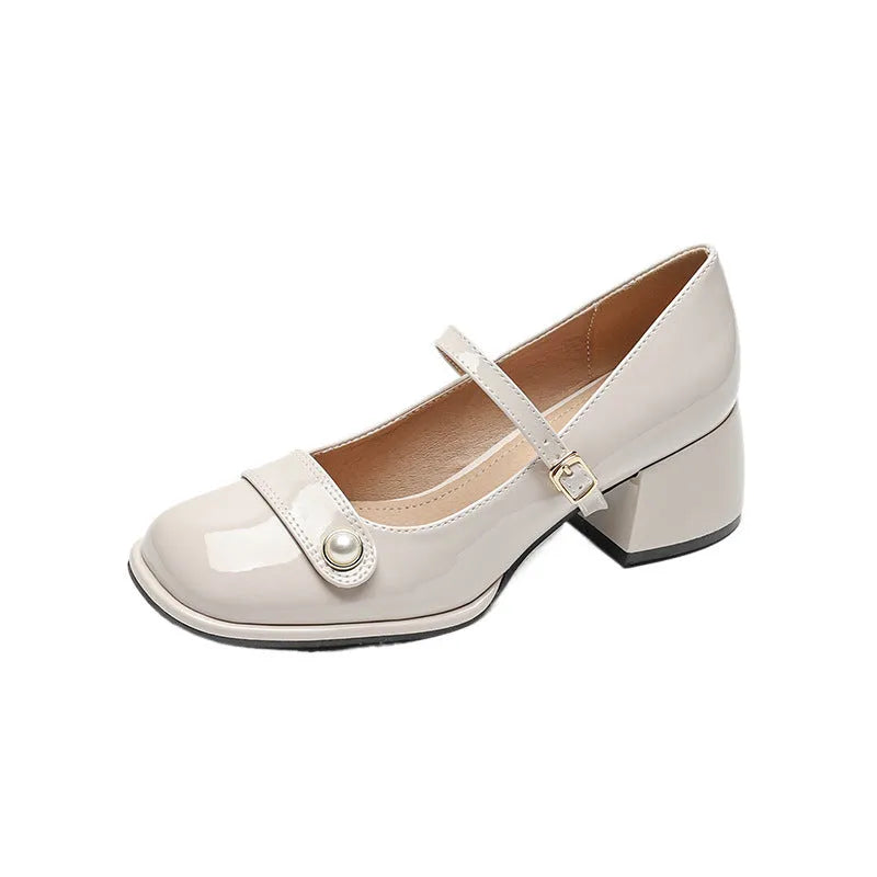 Women's apricot patent leather ankle boots with a chunky heel and ankle buckle.